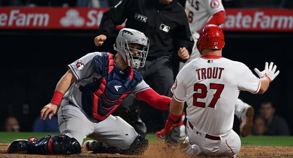 Mike Trout of Angels slides into home plate for a YRFI