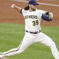 Corbin Burnes of Brewers pitches baseball pitches for a NRFI