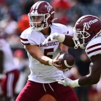 UMass football QB hands ball off to RB