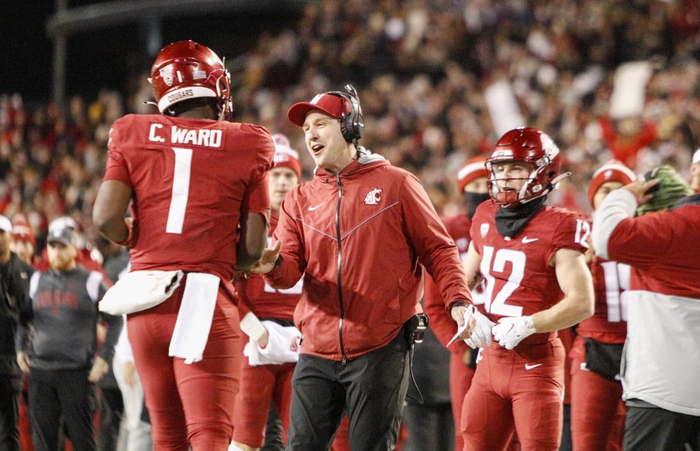 Washington State football team gathers on sideline
