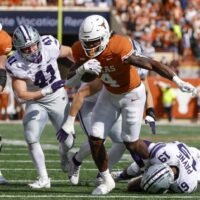 Texas football player CJ Baxter looks for the end zone.