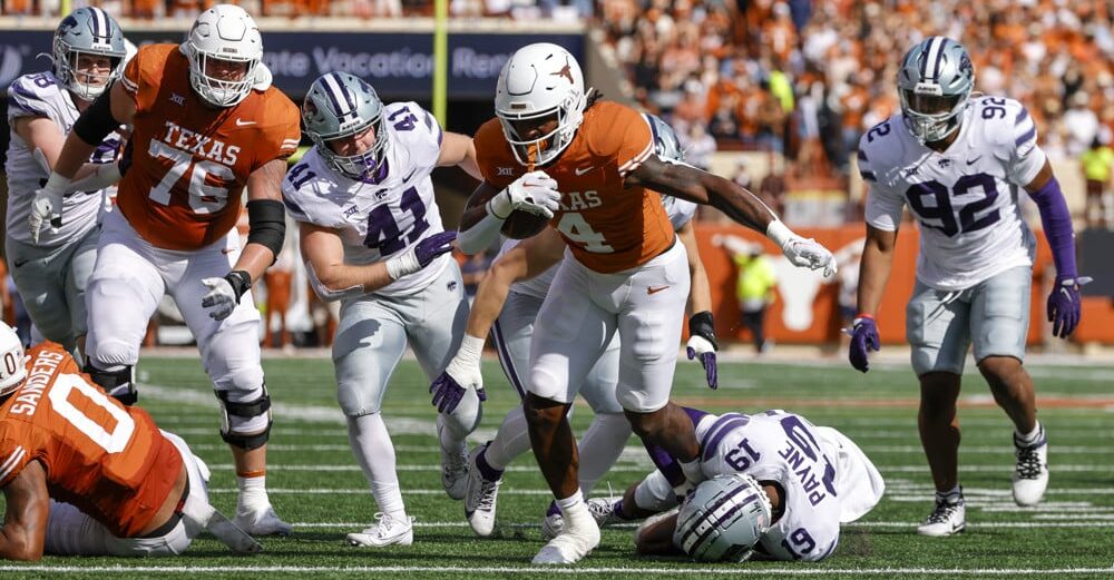 Texas football player CJ Baxter looks for the end zone.